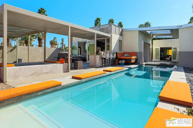 a view of a backyard with swimming pool