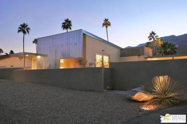 a living room with furniture kitchen view and a large window