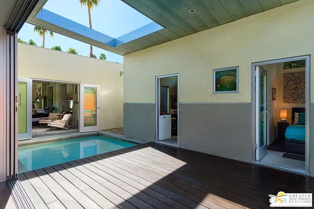 a view of a patio with wooden floor and plants