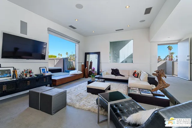 a bedroom with furniture and a large window