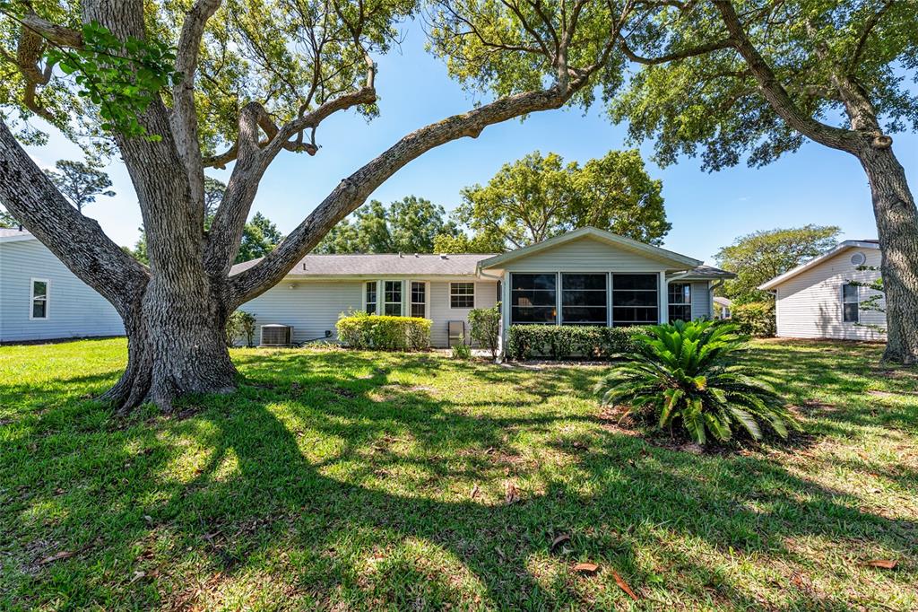 8038 Southwest 108th Loop Ocala, FL 34481 - Photo 36 of 48 a front view of a house with a garden