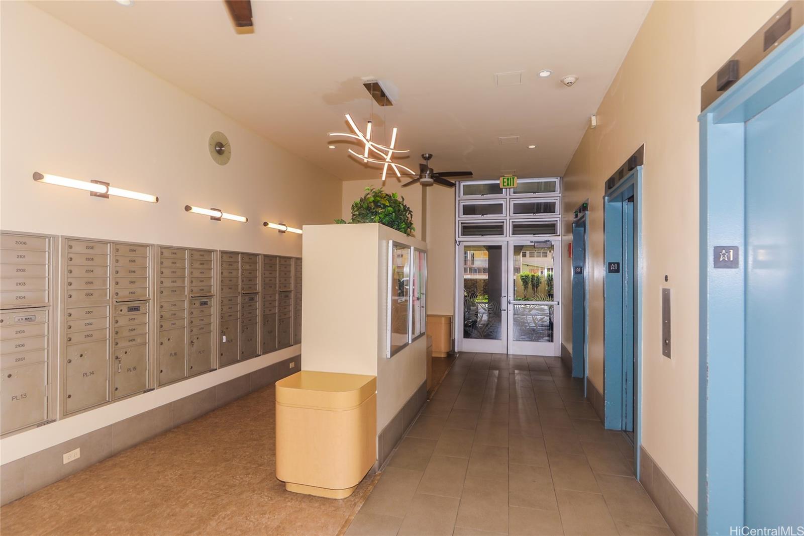 2525 Date Street, Unit 2303 Honolulu, HI 96826 - Photo 14 of 25 a view of hallway with stairs and a large window