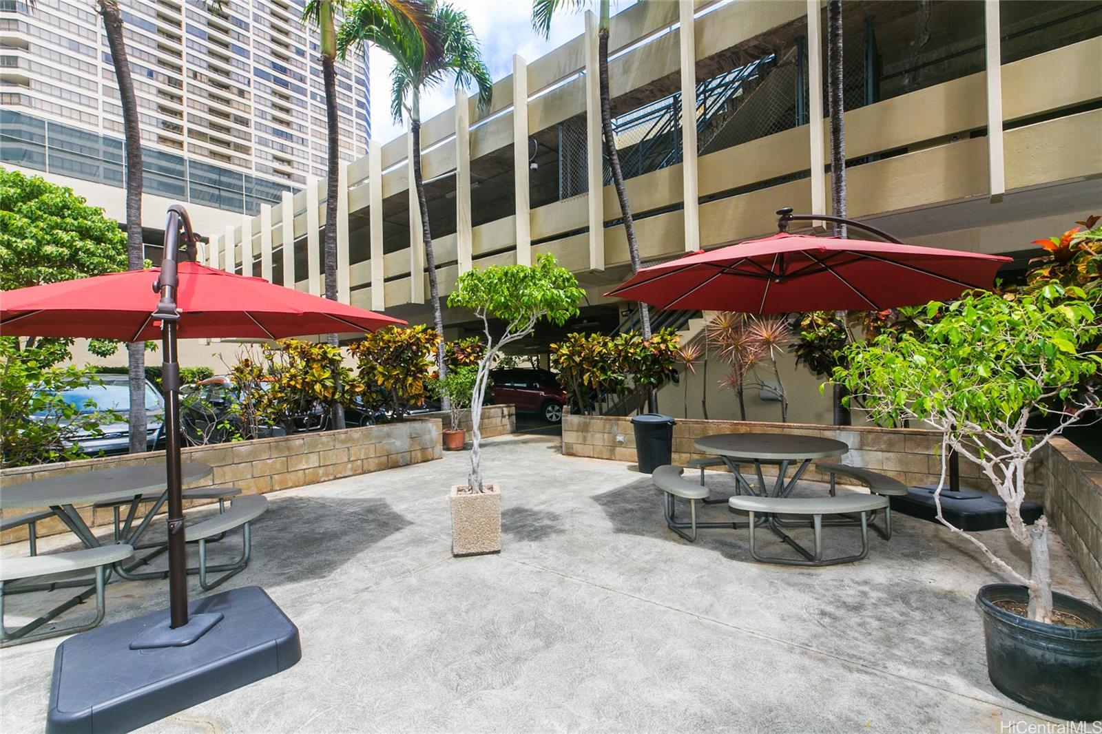 2525 Date Street, Unit 2303 Honolulu, HI 96826 - Photo 20 of 25 a view of a patio with a table and chairs under an umbrella