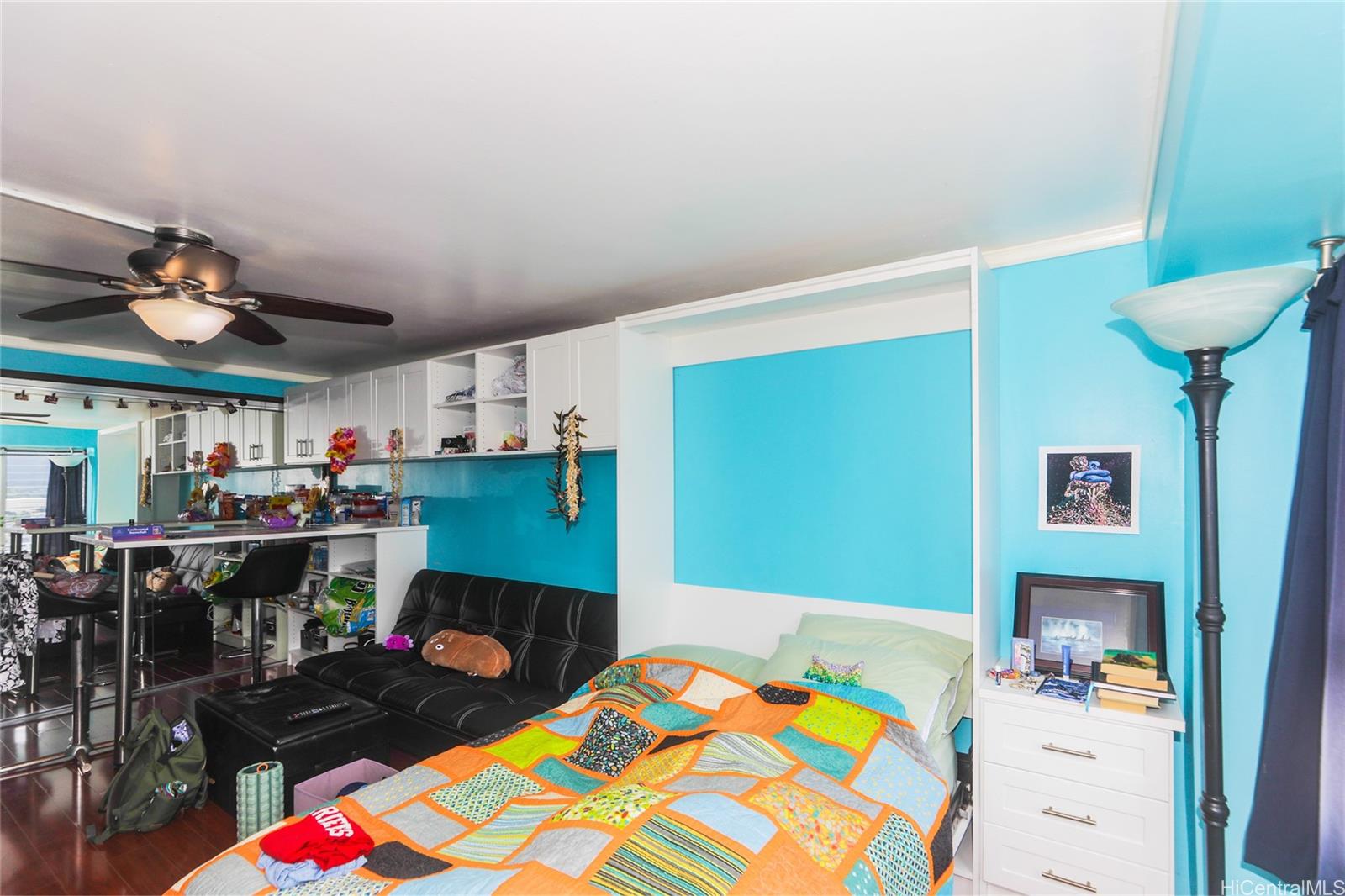 2525 Date Street, Unit 2303 Honolulu, HI 96826 - Photo 3 of 25 a bedroom with a bed and a table in it