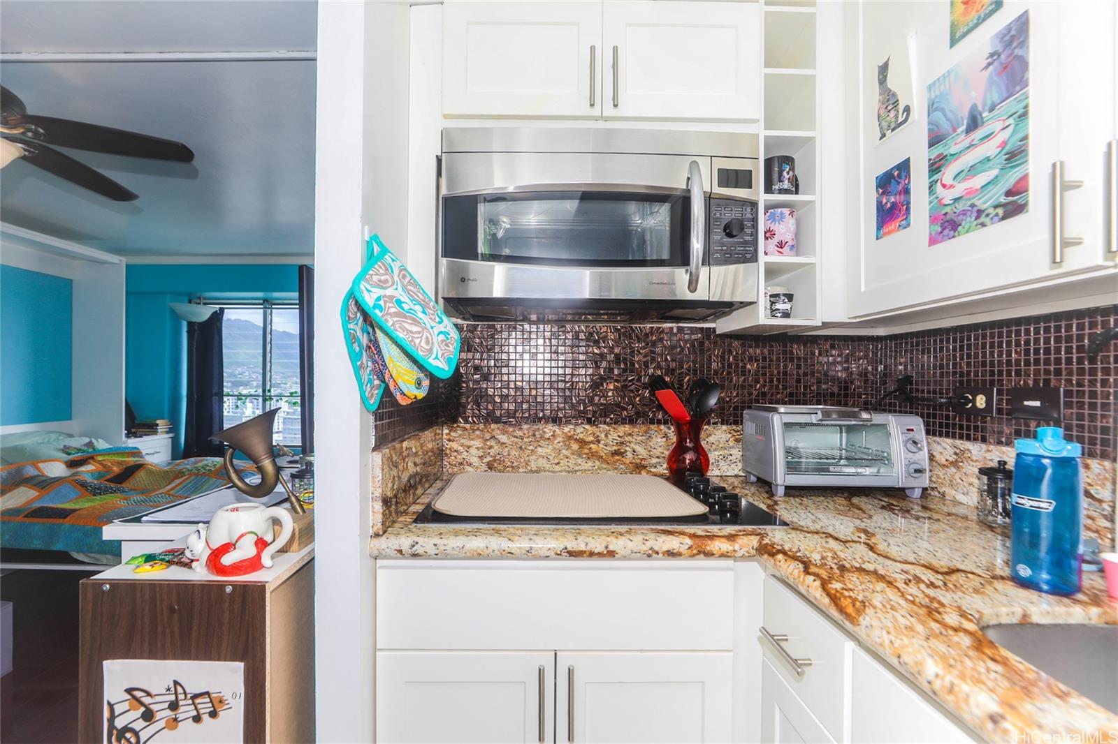 2525 Date Street, Unit 2303 Honolulu, HI 96826 - Photo 9 of 25 a kitchen with stainless steel appliances granite countertop a stove and a sink