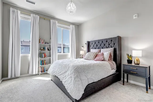 a bedroom with a bed and a chandelier