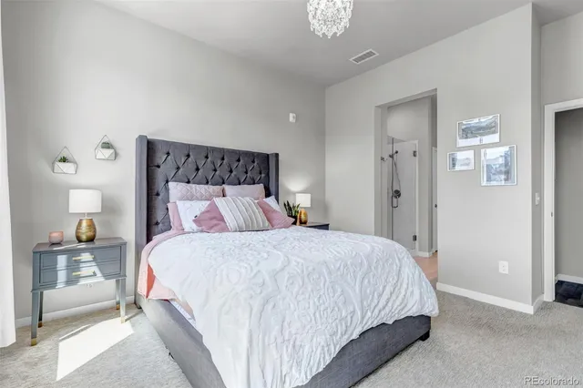 a bedroom with a bed and a lamp