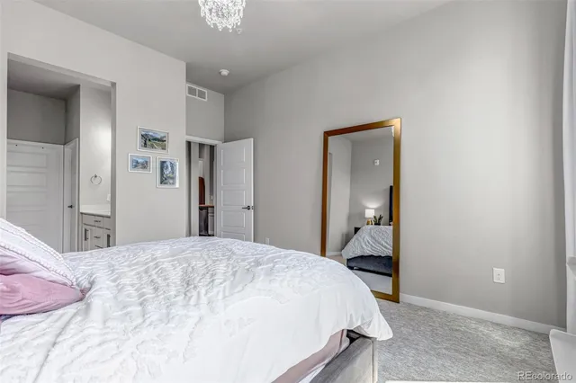 a bedroom with a bed and a mirror