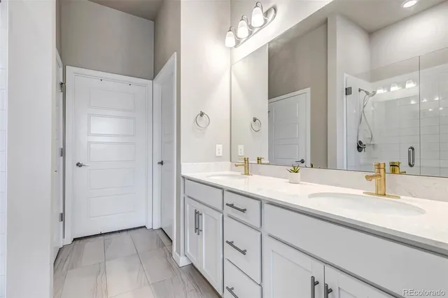 a bathroom with a double vanity sink mirror and