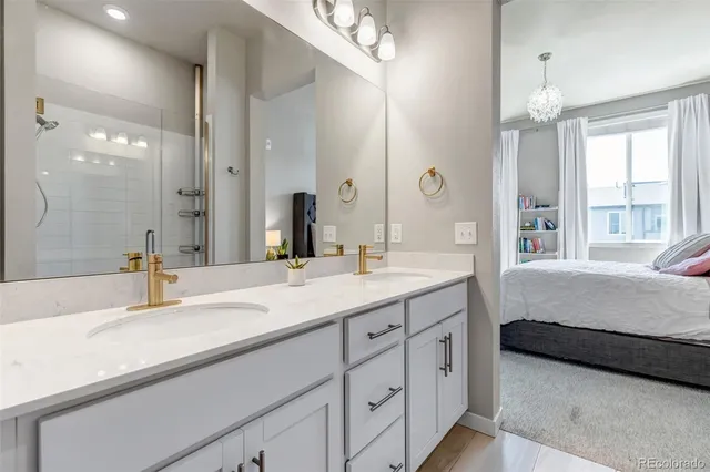 a en suite bathroom with sinks double vanity and a tub