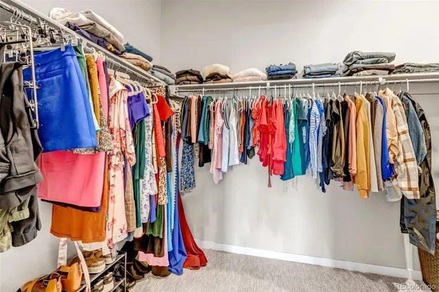 a view of walk in closet with clothes
