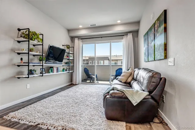 a living room with furniture window and flat screen tv