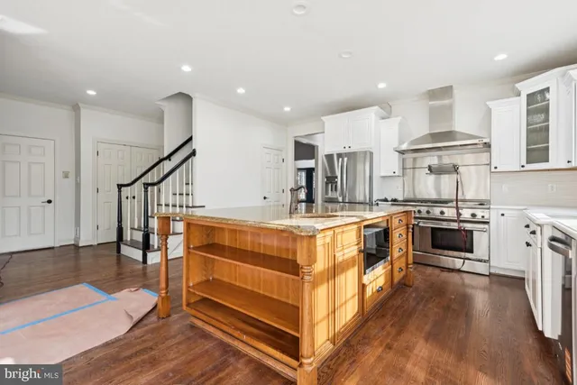 a kitchen with stainless steel appliances granite countertop a stove and a refrigerator