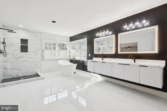 a large white bathroom with a large mirror vanity and a shower