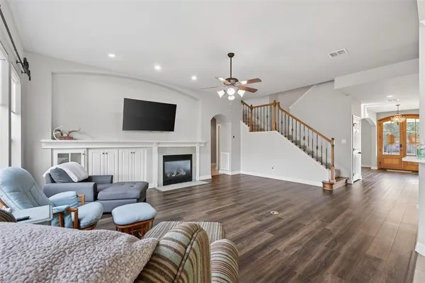a living room with furniture a fireplace and a flat screen tv