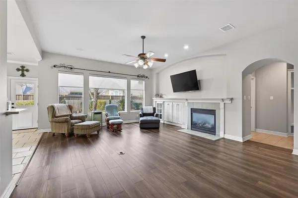 a living room with furniture floor to ceiling window and a fireplace
