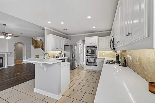 a kitchen with stainless steel appliances kitchen island granite countertop a sink and cabinets