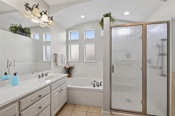 a spacious bathroom with a double vanity sink mirror and shower