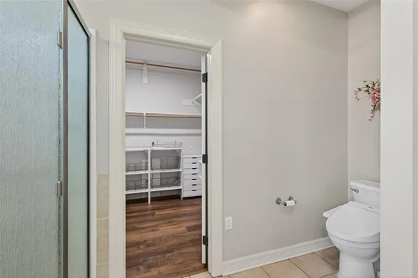 a bathroom with a toilet and a shower