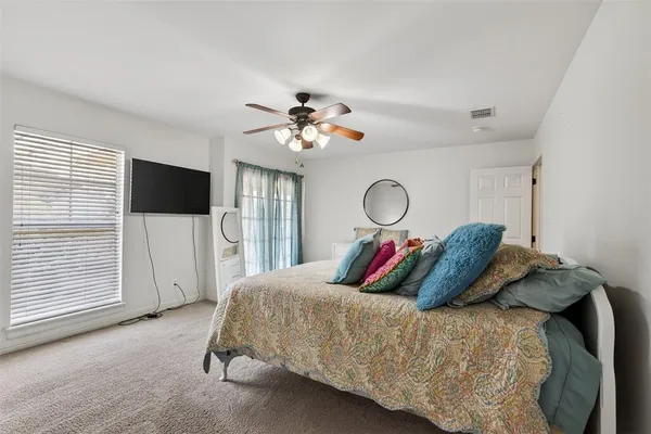 a bed room with a bed mirror and a window