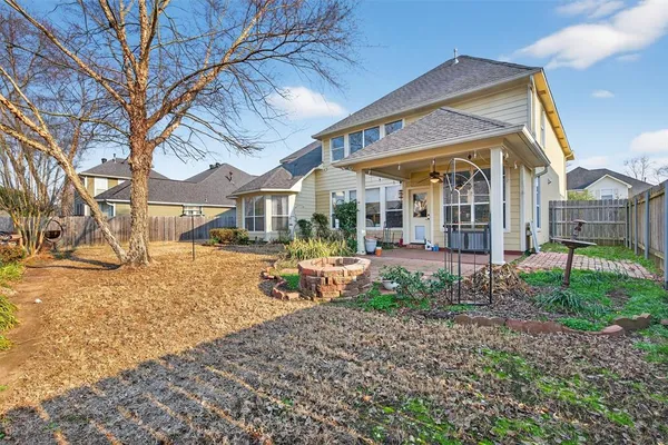 a view of a house with a yard and pathway