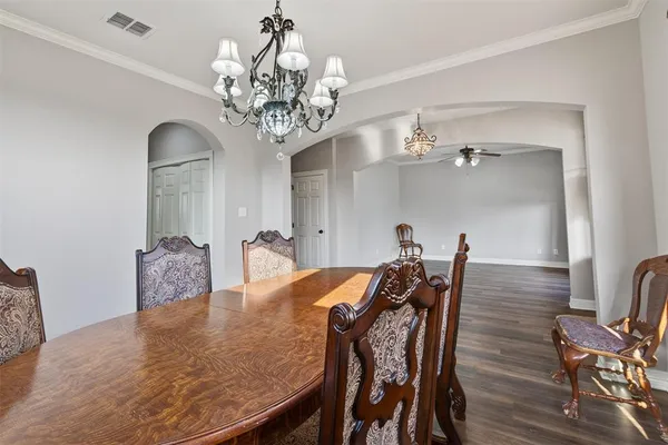a view of a dining room with furniture and chandelier