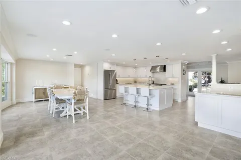 a large kitchen with a table and chairs