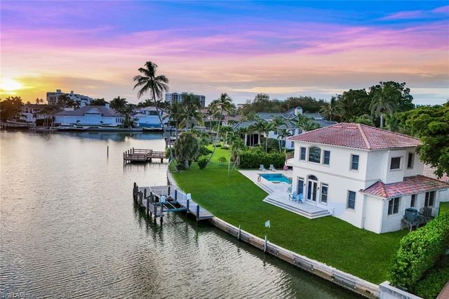 a view of a lake with a house in the background