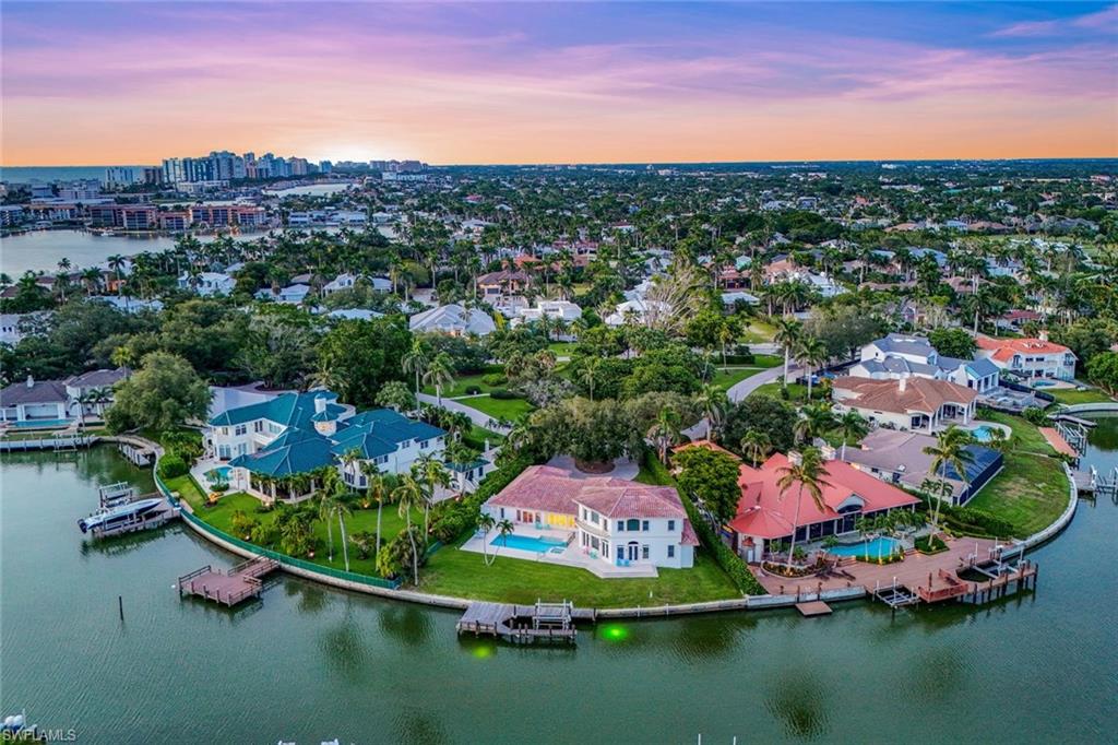 350 Bowline Bend Naples, FL 34103 - Photo 16 of 33 Aerial view at dusk of a water view, a residential view, and a skyline view