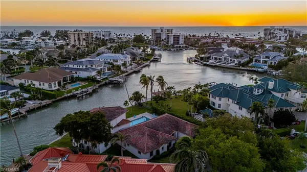 an aerial view of residential houses with outdoor space and lake view