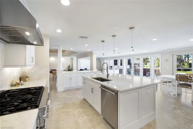 a kitchen with stainless steel appliances granite countertop a sink and cabinets