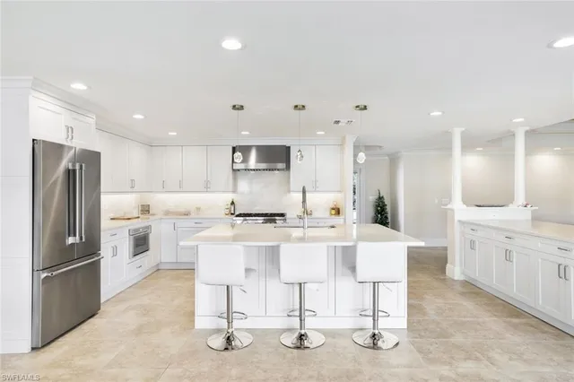 a kitchen with stainless steel appliances kitchen island granite countertop a sink and cabinets