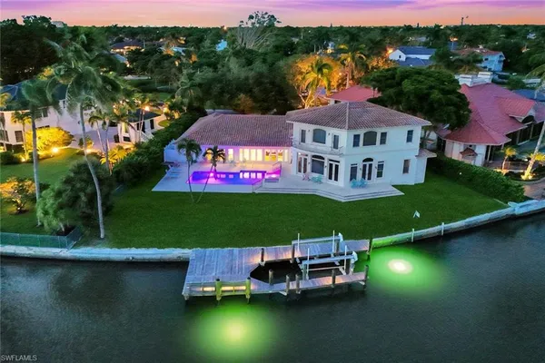 an aerial view of a house with swimming pool outdoor seating and yard