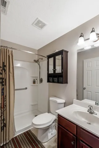 a bathroom with a sink toilet and shower