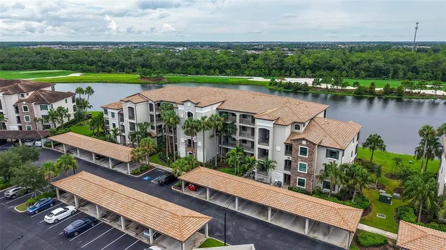 an aerial view of a house with a garden and lake view