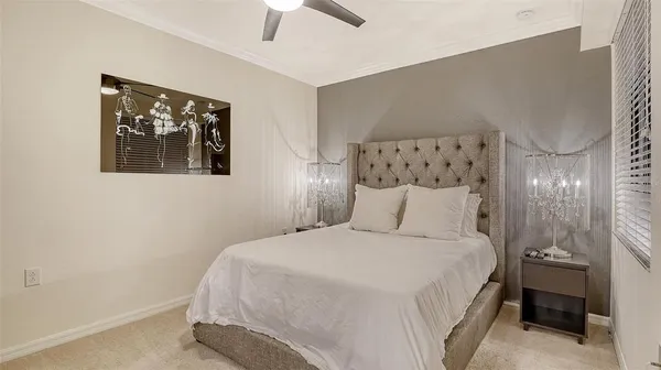 a bedroom with a bed and a ceiling fan