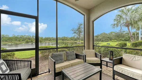 a living room with furniture and a floor to ceiling window