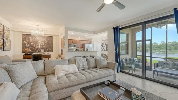 a living room with furniture and a floor to ceiling window