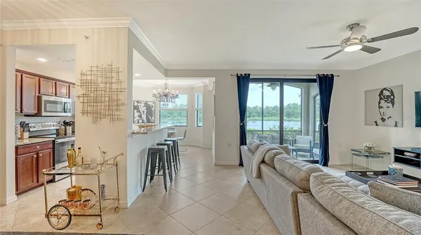 a living room with furniture windows and a chandelier