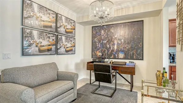 a view of a livingroom with furniture and chandelier