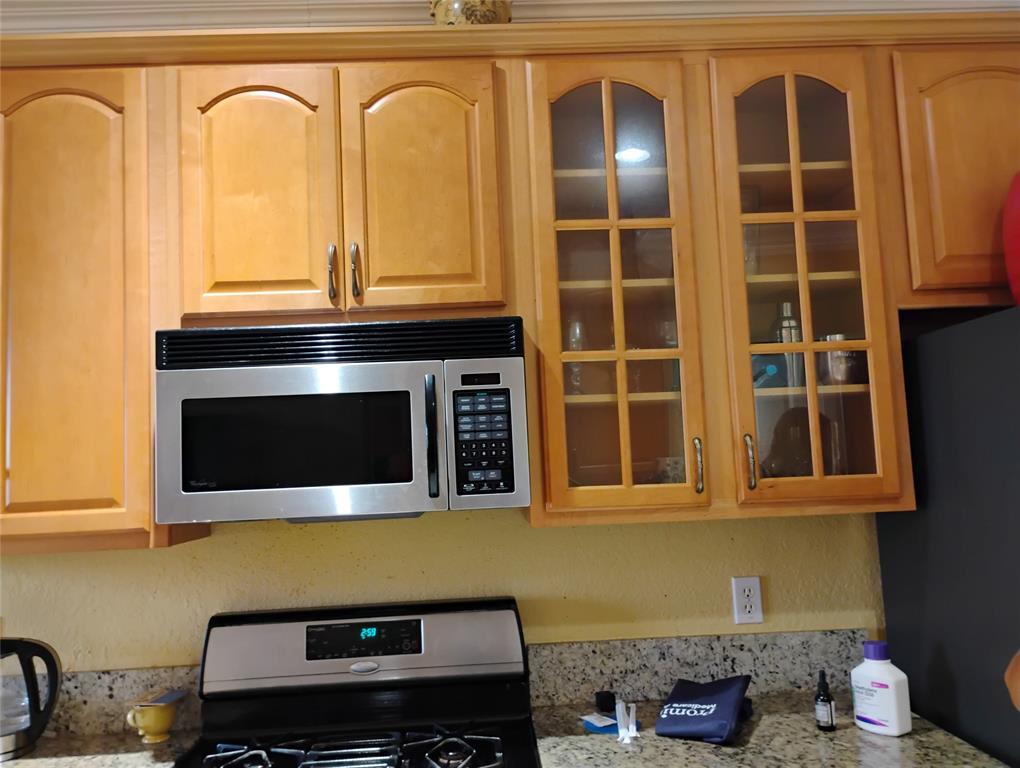 Undisclosed Address Royal Palm Beach, FL 33414 - Photo 12 of 32 a kitchen with a stove and a microwave