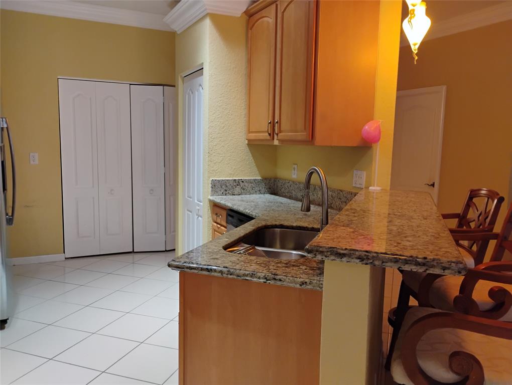 Undisclosed Address Royal Palm Beach, FL 33414 - Photo 16 of 32 a kitchen with a sink a stove and a refrigerator