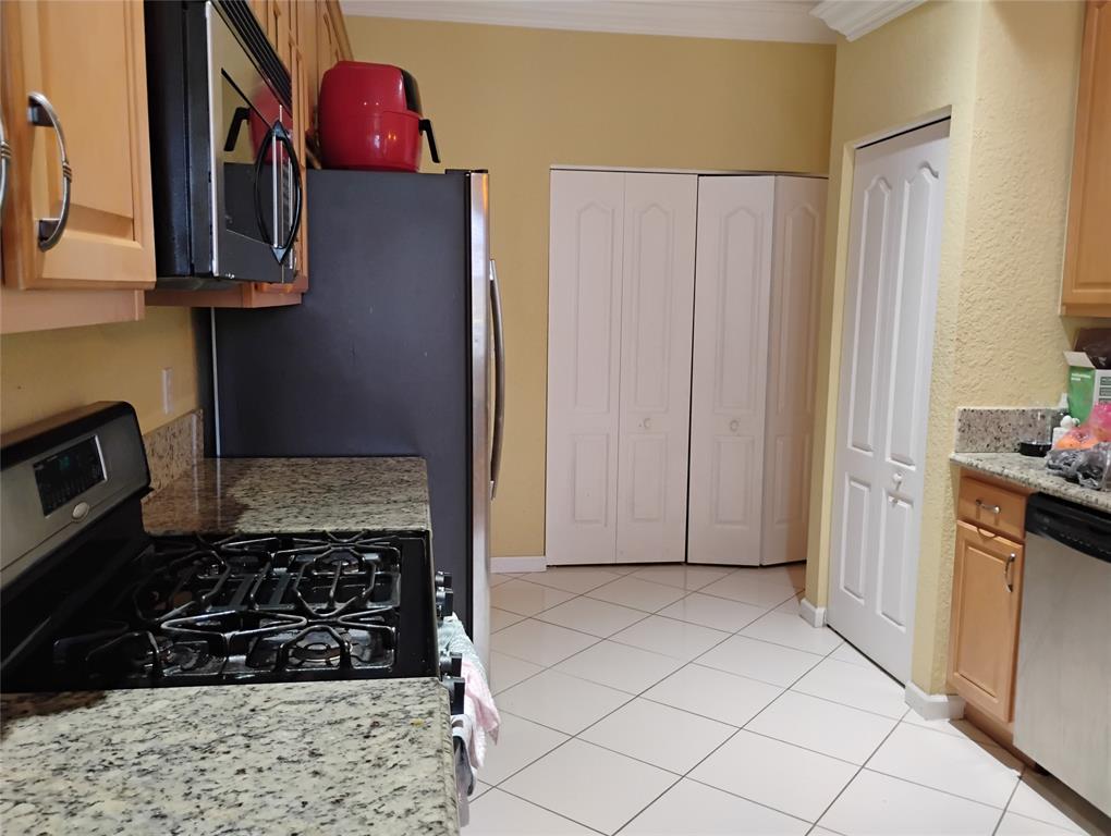 Undisclosed Address Royal Palm Beach, FL 33414 - Photo 17 of 32 a kitchen with stainless steel appliances granite countertop a refrigerator and a stove top oven