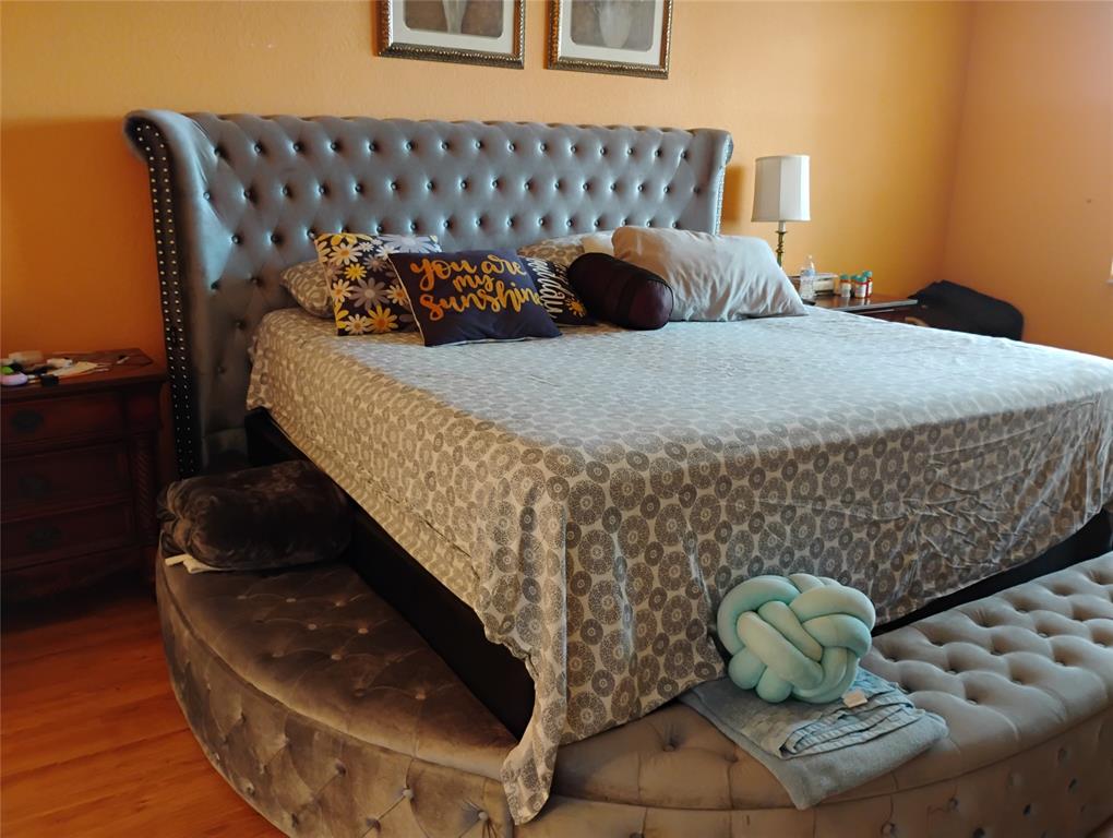 Undisclosed Address Royal Palm Beach, FL 33414 - Photo 22 of 32 a bed sitting in a bedroom next to a window with wooden floor