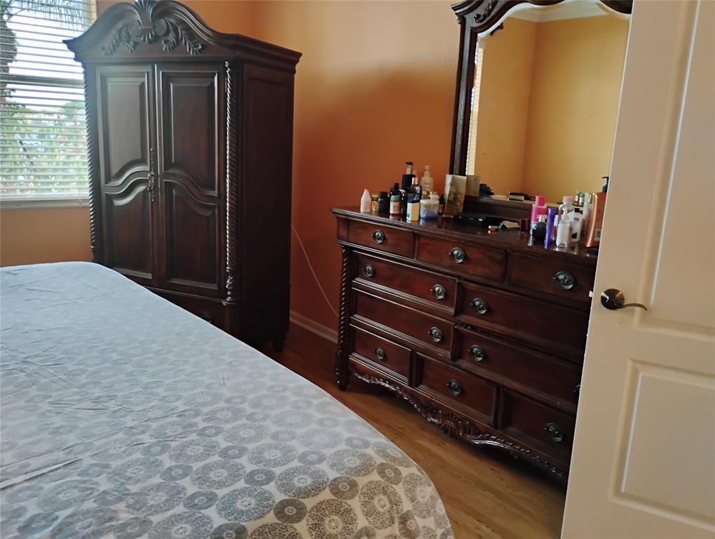 Undisclosed Address Royal Palm Beach, FL 33414 - Photo 23 of 32 a bedroom with a bed and a mirror