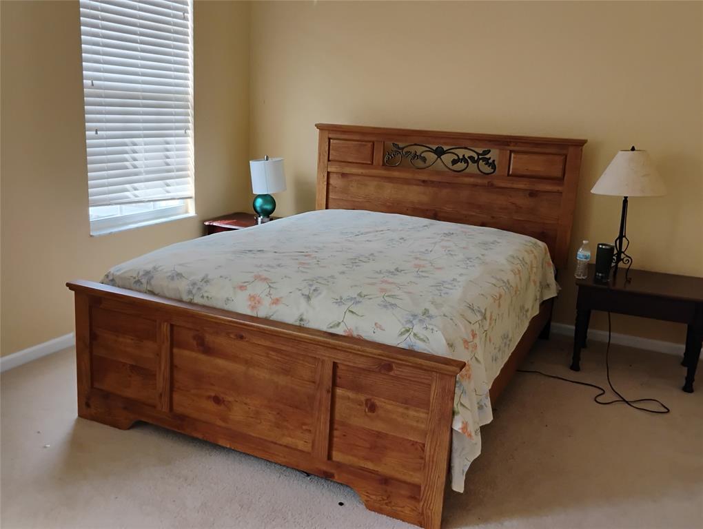 Undisclosed Address Royal Palm Beach, FL 33414 - Photo 27 of 32 a bed sitting in a bedroom next to a window