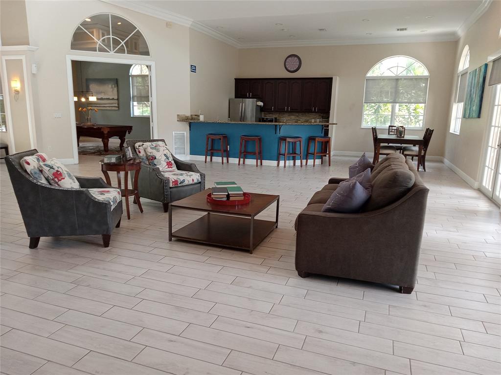 Undisclosed Address Royal Palm Beach, FL 33414 - Photo 29 of 32 a living room with furniture a fireplace and a flat screen tv