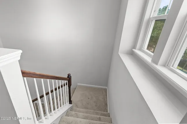 an empty room with a window and a ceiling fan
