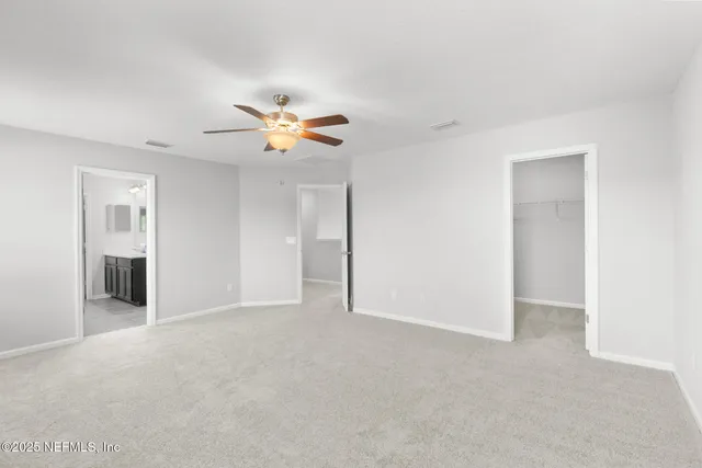 a view of a livingroom with a ceiling fan and window