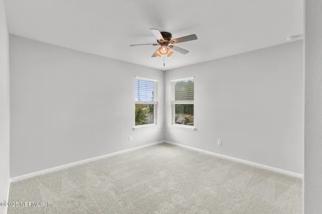 a view of a backyard with a garden and trees